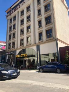 a large building with cars parked in front of it at Sanli Hotel Hammam & SPA in Trabzon