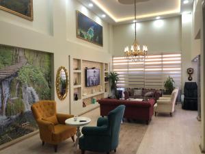 a living room with couches and chairs and a chandelier at Sanli Hotel Hammam & SPA in Trabzon