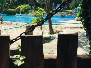 a fence with a rope in front of a swimming pool at Damouchari Hotel in Damouchari +17 photos