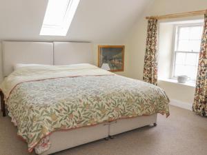 a bedroom with a bed and a window at The Cottage, Polwarth Crofts in Duns