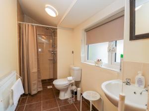 a bathroom with a toilet and a sink and a shower at 18 Howard Street in Scarborough +8 photos