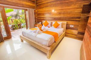 Ein Bett oder Betten in einem Zimmer der Unterkunft Dinatah Lembongan Villas