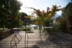two chairs sitting on a wooden deck with a table at Dreamers in Mount Beauty