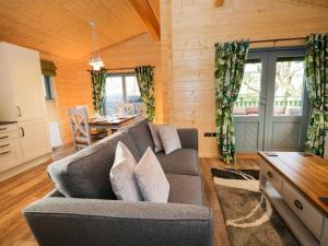 a living room with a couch and a table at Oak Lodge in Ulverston