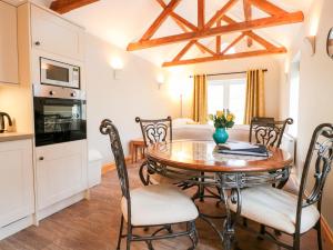 a kitchen and dining room with a table and chairs at Old Sorting Office in Cheltenham