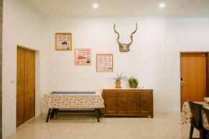 a room with a table and a cabinet with a plant on it at He Sen B&B in Kenting +37 photos