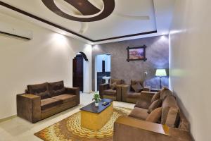 a living room with couches and a coffee table at فواصل تبوك Fawasel Tabuk in Tabuk