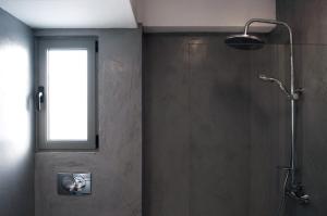 a bathroom with a shower with a window at Acropolis View Rooftop Apartment Athens in Athens +23 photos