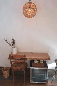 a wooden table with a chair and a lamp at Stonehill's Farmhouse in Accord