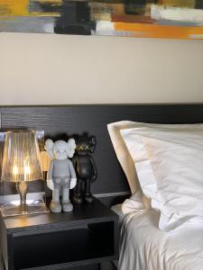 a bedroom with a bed with a nightstand with a lamp at Bue Nero Suites Verona in Verona +27 photos