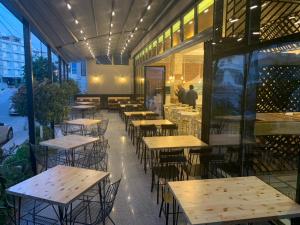 a row of tables and chairs in a restaurant at Eval Hotel in Sarandë