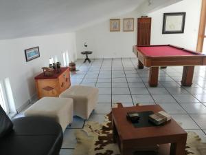 a living room with a pool table and a couch at Casa da Torre in Angra do Heroísmo