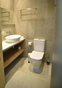 a bathroom with a toilet and a sink at Hai Hotel in Larnaca