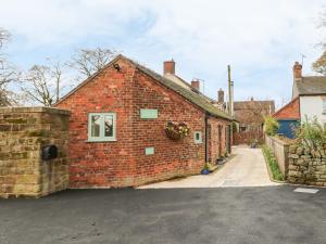 a red brick building with a window on it at The Old Sty in Whiston