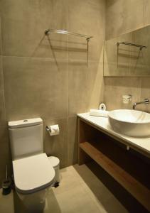 a bathroom with a toilet and a sink at Hai Hotel in Larnaca