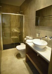 a bathroom with a sink and a toilet and a shower at Hai Hotel in Larnaca