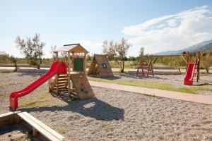a playground with a slide and a play structure at Apartmani Lea in Starigrad