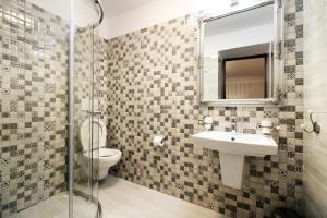 a bathroom with a toilet and a sink and a mirror at Select House in Sibiu +68 photos