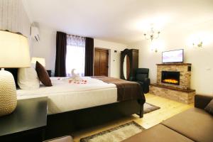 a hotel room with a bed and a fireplace at Select House in Sibiu