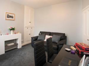 a living room with a couch and a table at Hirfron in Llanberis