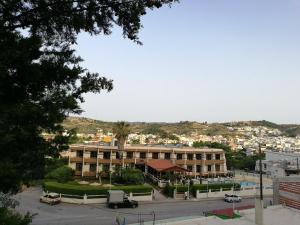 a large building with a parking lot in front of it at Golden days in Afantou