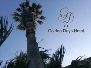 a palm tree with the words golden days hotel at Golden days in Afantou