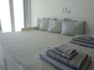 two folded towels sitting on a counter in a room at Athani Summer House (Apartments 03 - 04) in Athanion