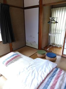 מיטה או מיטות בחדר ב-Guesthouse Yashima
