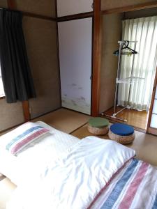Postel nebo postele na pokoji v ubytování Guesthouse Yashima