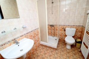 a bathroom with a toilet and a sink and a shower at Toncho's Guest House for 16 guests in Arbanasi