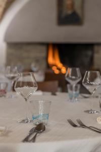 - une table avec quatre verres à vin et de l'argenterie dans l'établissement Don Pasquale Picciano- PESCARA-ABRUZZO, à Picciano
