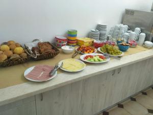 a counter top with plates of food on it at Golden days in Afantou