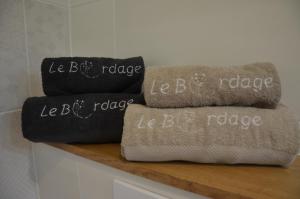 two pillows sitting on top of a wooden shelf at La Remise 4 étoiles in Saint-Hilaire-de-Mortagne +7 photos