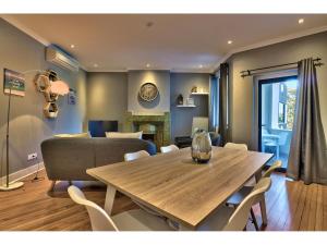 a dining room with a table and a couch at Greenpoint Apartments in Cape Town