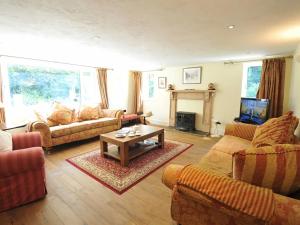 a living room with couches and a coffee table at Melin y Coed in Menai Bridge