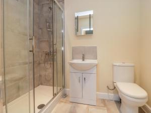 a bathroom with a shower and a toilet and a sink at Oak Lodge in York +10 photos