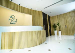 a lobby of a hotel with a sign on the wall at Hai Hotel in Larnaca