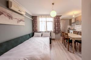 a small room with a bed and a table at Masal Apart in Istanbul