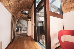 a room with a wooden floor and a large window at Antico Borgo Chieti in Chieti