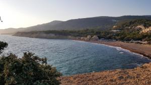 a beach with a group of people on the shore at Limeri Traditional Guest House in Monólithos