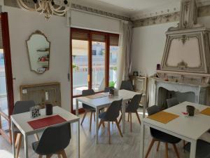 a dining room with tables and chairs and a fireplace at La Dimora del Conte in Pescara