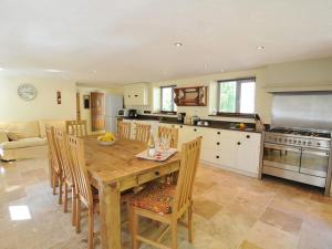 a kitchen and dining room with a wooden table and chairs at Melin y Coed in Menai Bridge
