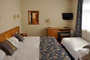 Säng eller sängar i ett rum på Hotel Crunia I A Coruña