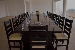 a long table with chairs and bottles of water on it at Hotel RRU Diamante in Acapulco +37 photos