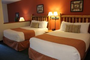 a hotel room with two beds and two lamps at The Waters of Minocqua in Minocqua