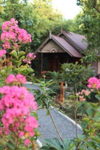 a garden with pink flowers in front of a building at Lanta Happy Hill in Ko Lanta