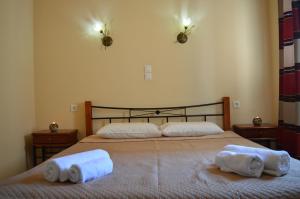 a bedroom with two beds with towels on them at Garden View Apartments in Anaxos