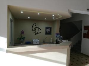 a room with a counter with a sign on the wall at Golden days in Afantou
