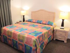 a hotel room with a bed and two lamps at Grand Lake & Lifetime of Vacations Resorts in Orlando
