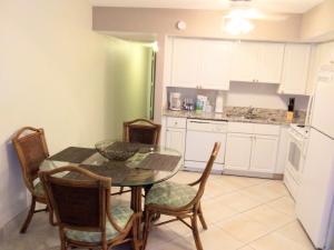 a kitchen with a table and chairs and a refrigerator at Grand Lake & Lifetime of Vacations Resorts in Orlando